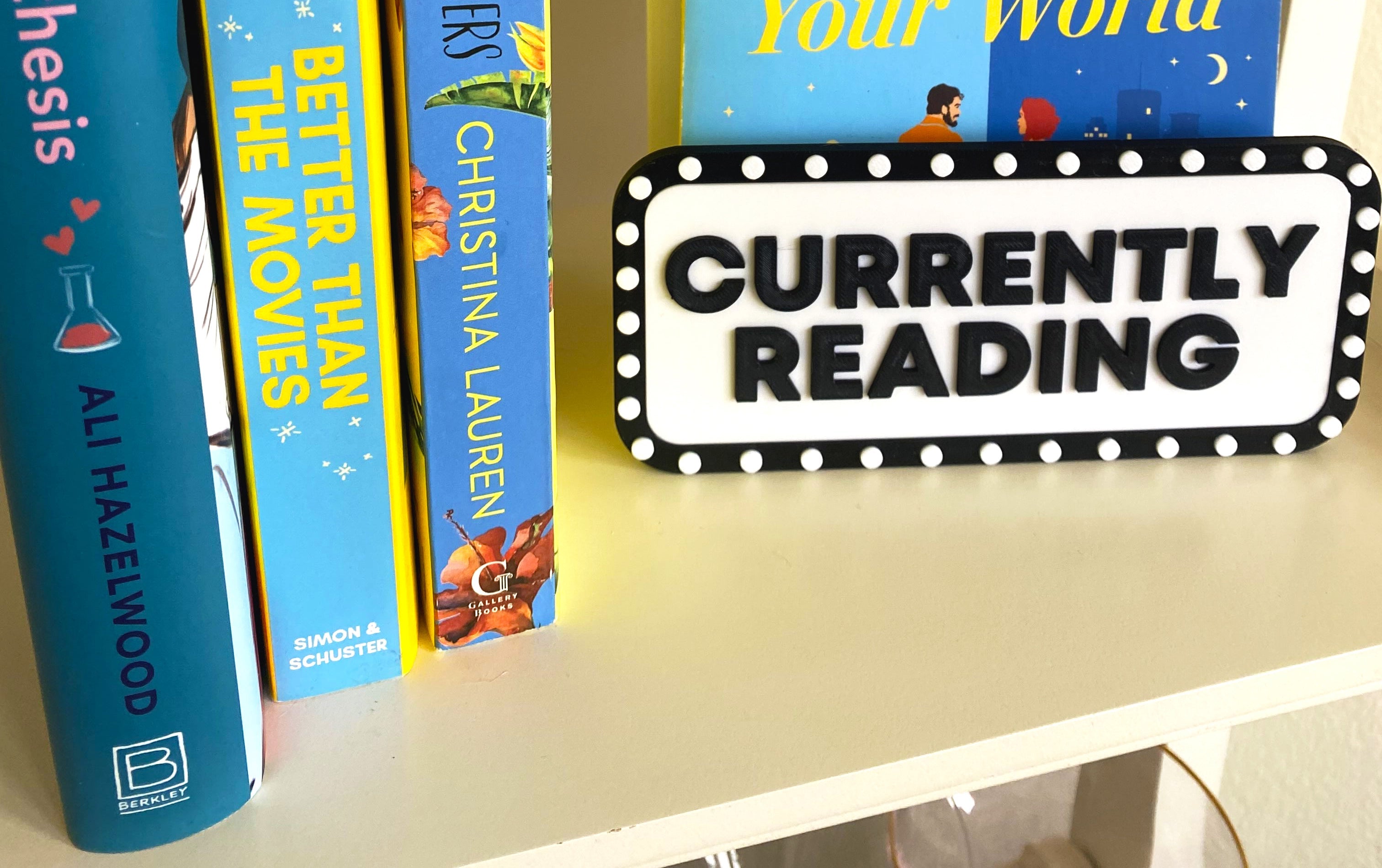 Currently Reading marquee sign beside colorful book spines